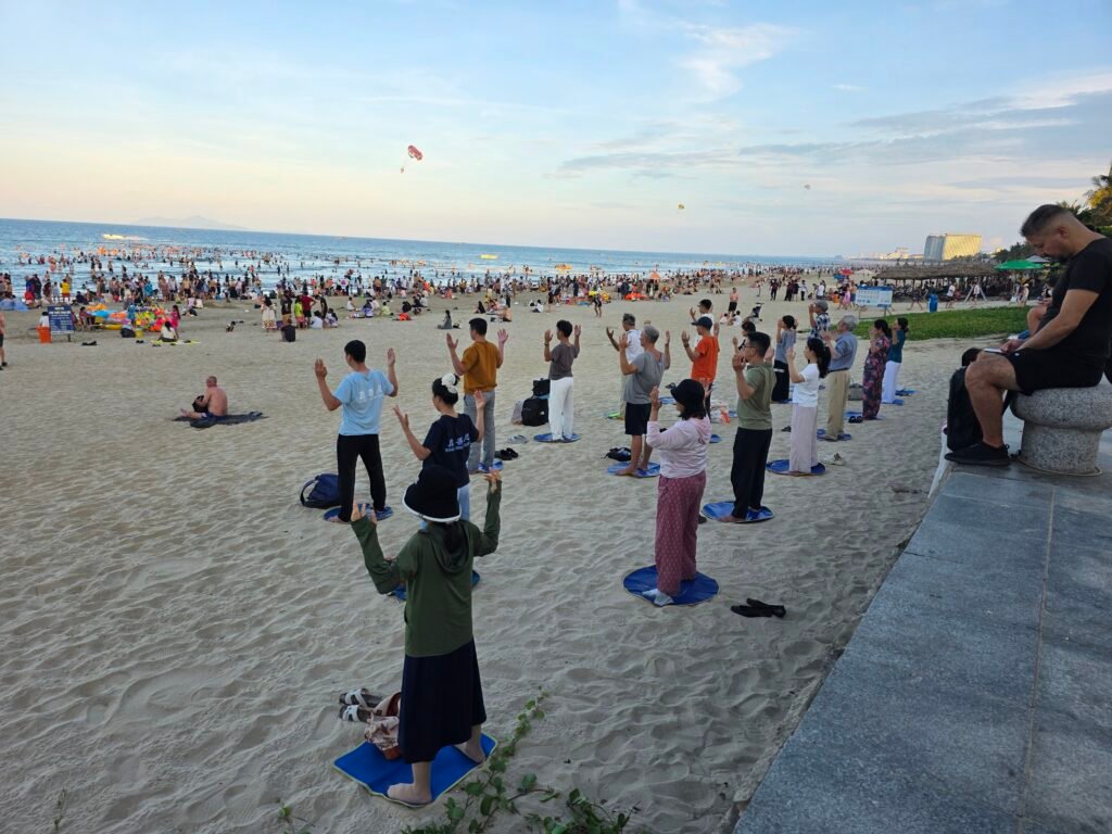 People exercising together on the beach in Da Nang, Vietnam