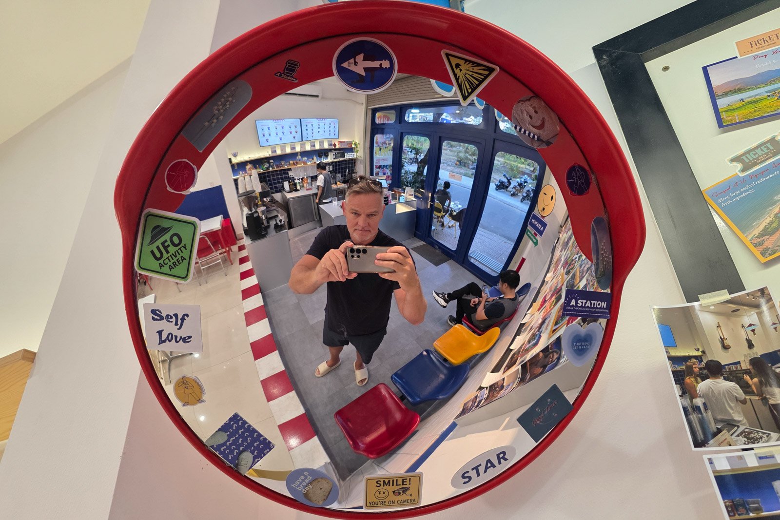 "Digital marketer reflected in a roadside convex mirror at a café, symbolizing the shift from websites to personal brands in affiliate marketing."