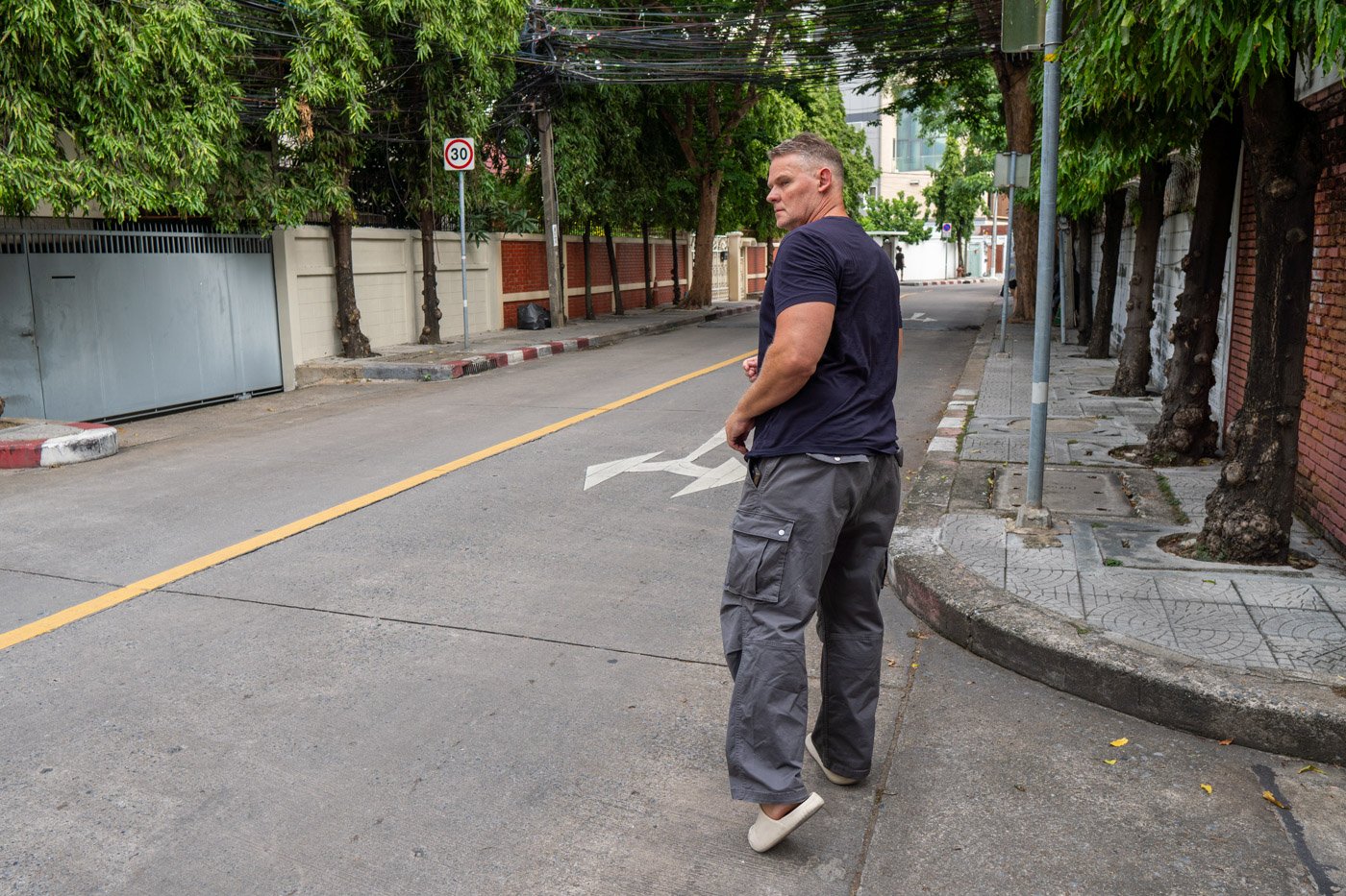 Walking through a quiet street in Ari, Bangkok, symbolizing independence, optionality, and the freedom to choose your own path.